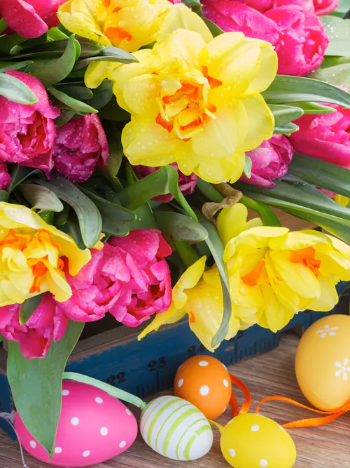 Colorful Easter eggs with spring flowers in festive display